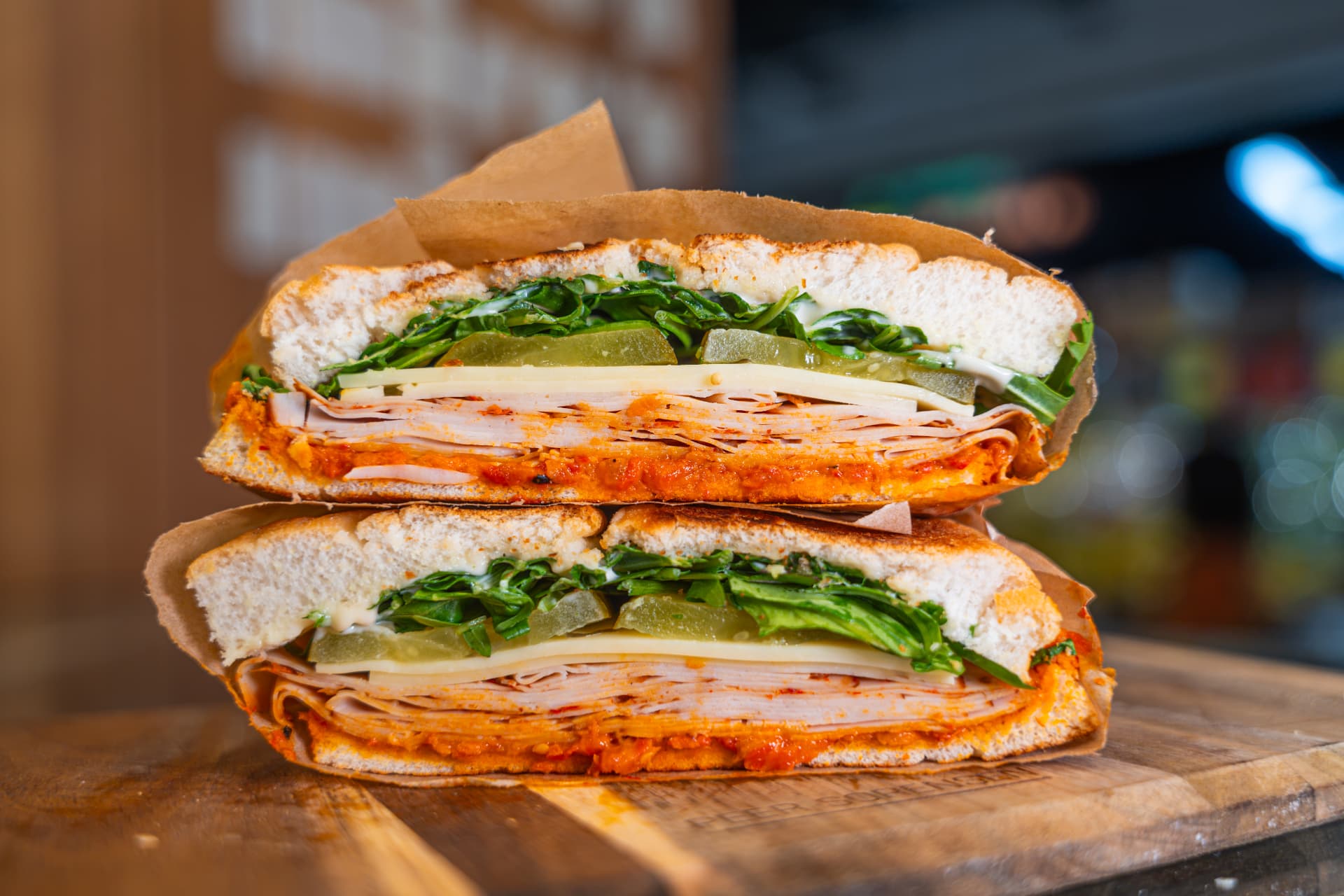 Chilli Chicken focaccia sandwich stacked and wrapped.